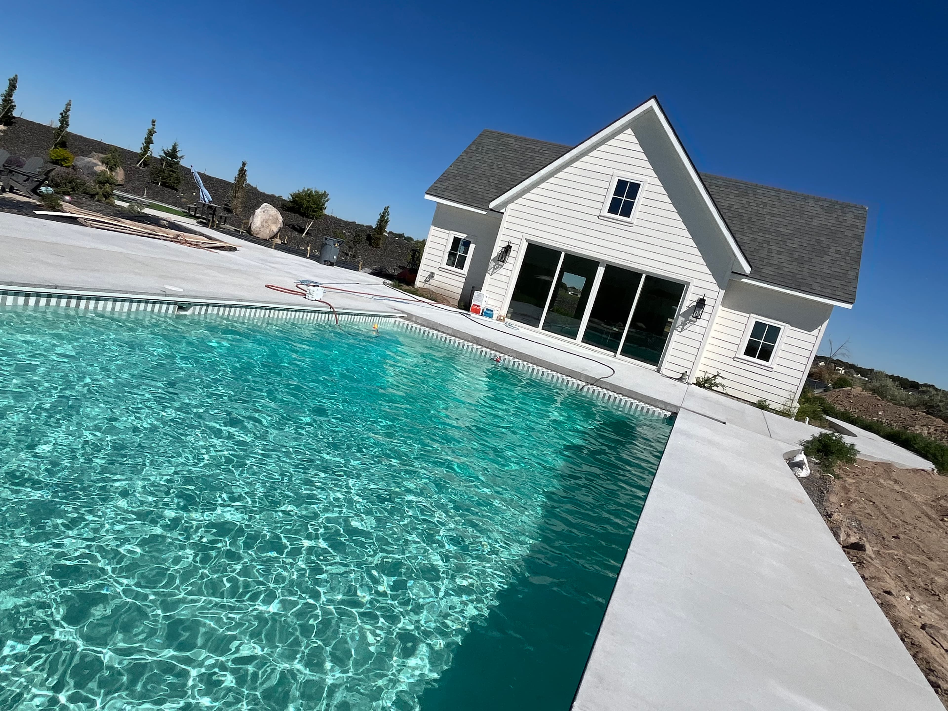 Finished pool — turquoise water, Idaho farmhouse